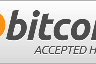 Bitcoin logo with 'Accepted Here' sign on a shop window